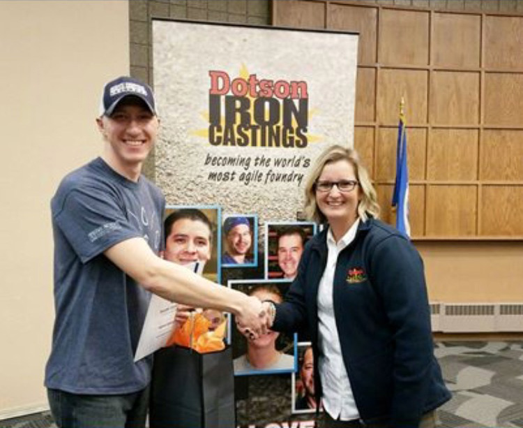 Scholarship Recipient shaking hands with Dotson employee